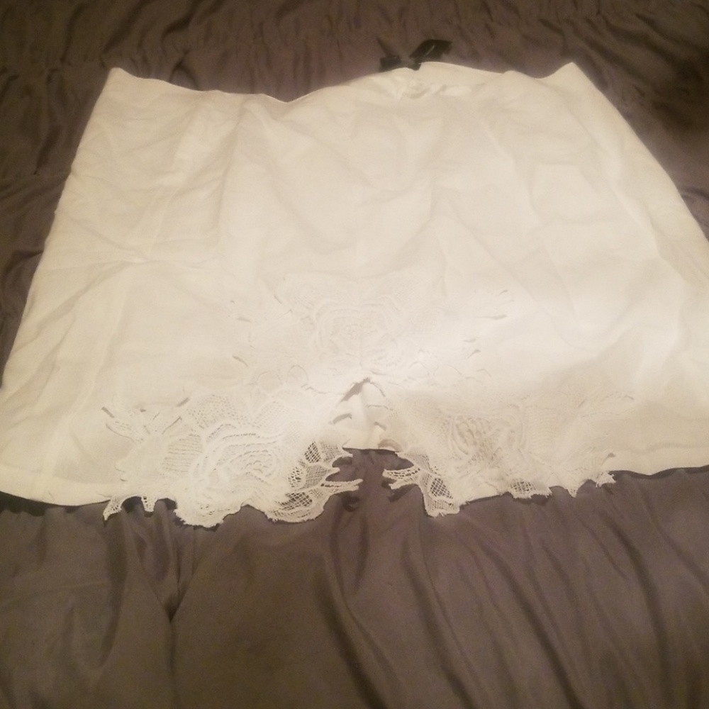 White skirt with lace slit in the front.
